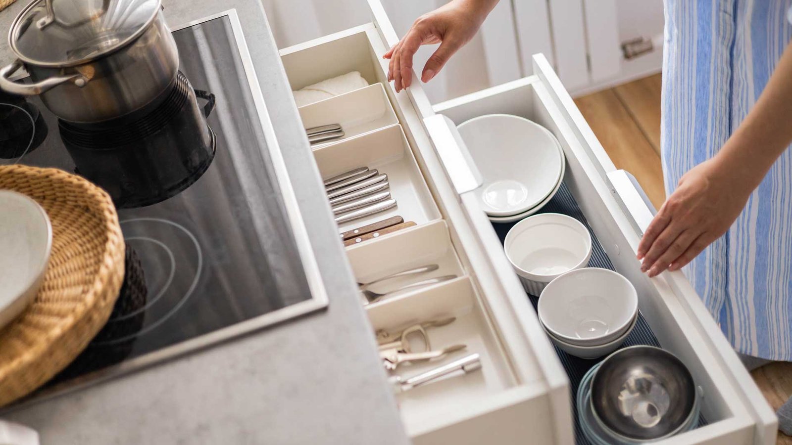 woman organize kitchen draws.